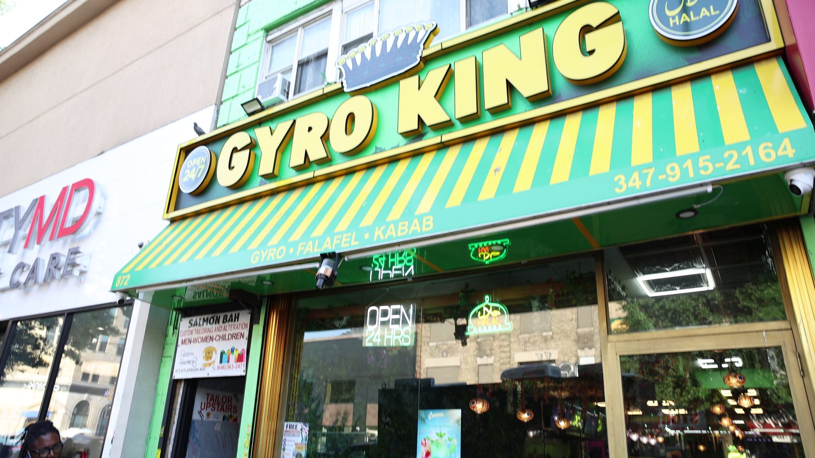 The Gyro King storefront on Flatbush Avenue, with its green-and-yellow awning and sign, photographed from the street